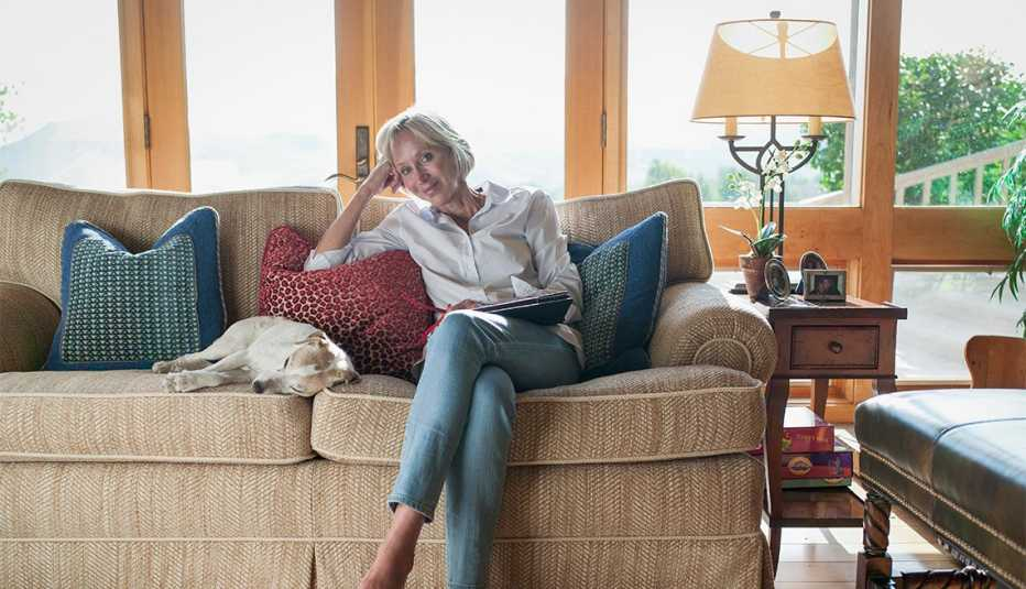 Elegant older woman using a device at home