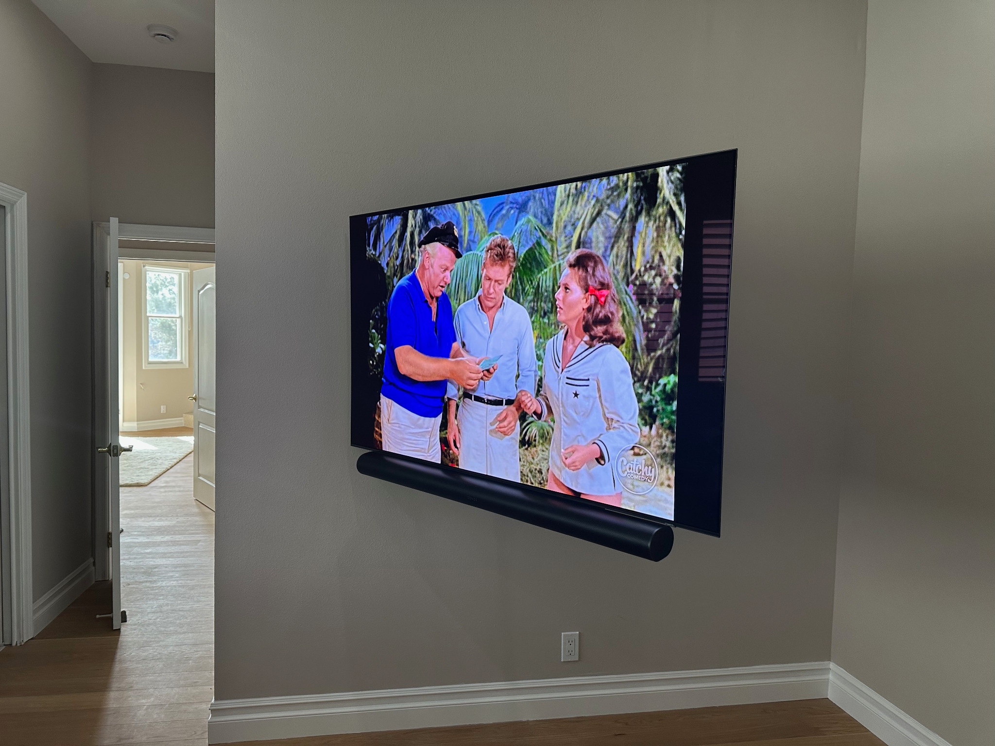 Wall-mounted television with soundbar