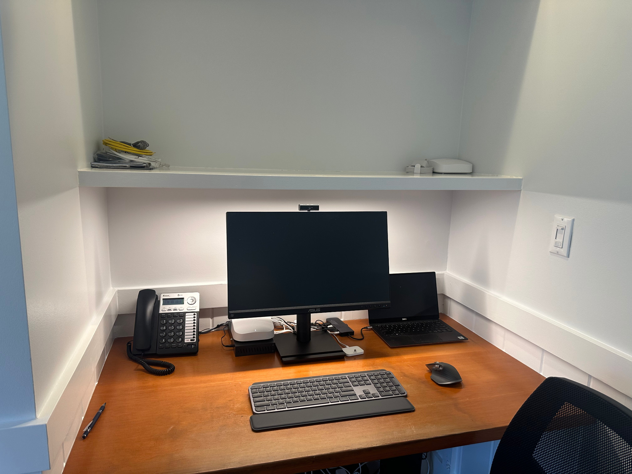 Clean workstation setup with monitor, laptop, and keyboard